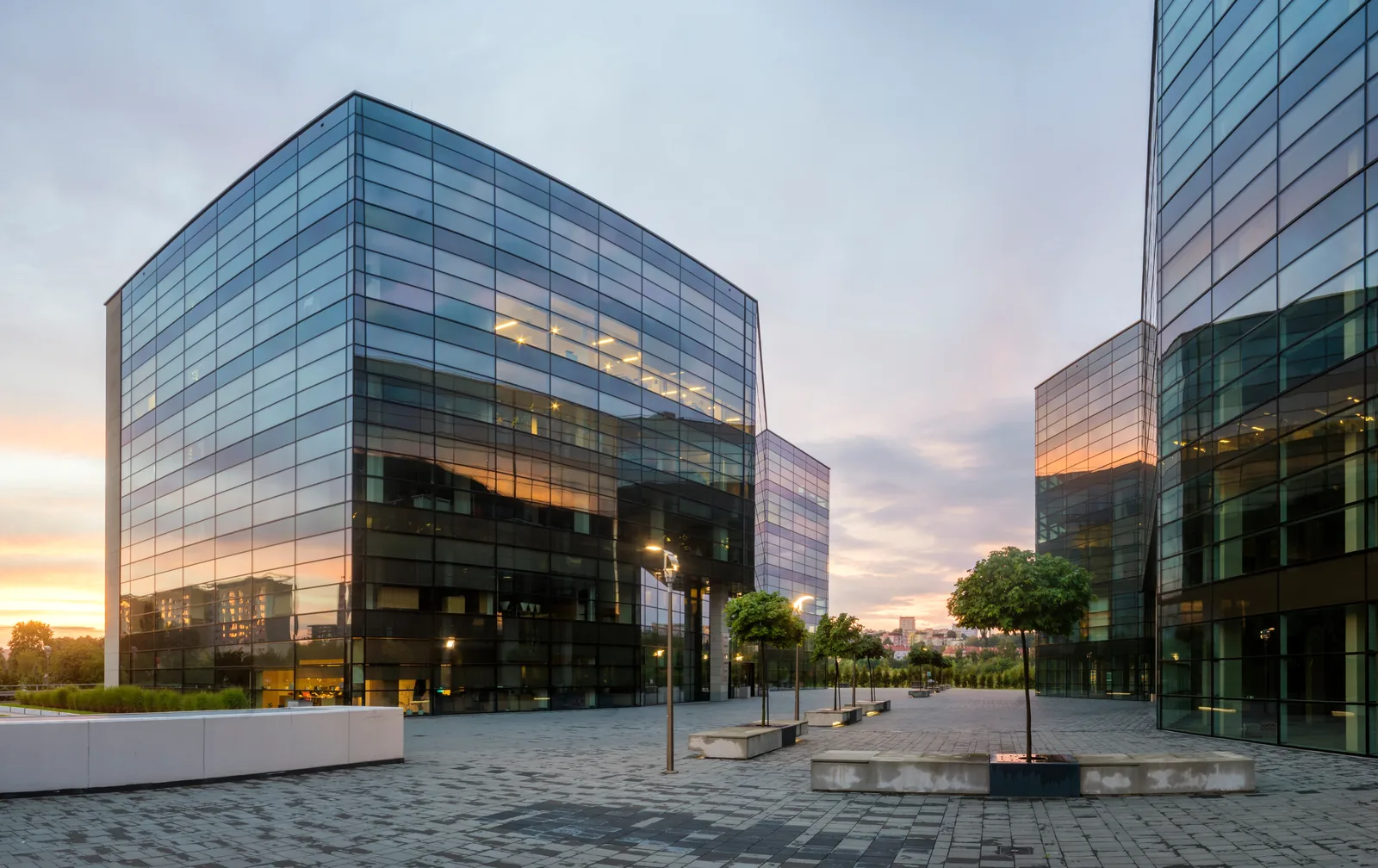 Modern glass-fronted commercial office buildings at dusk